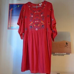 Red dress with floral embroidered details.